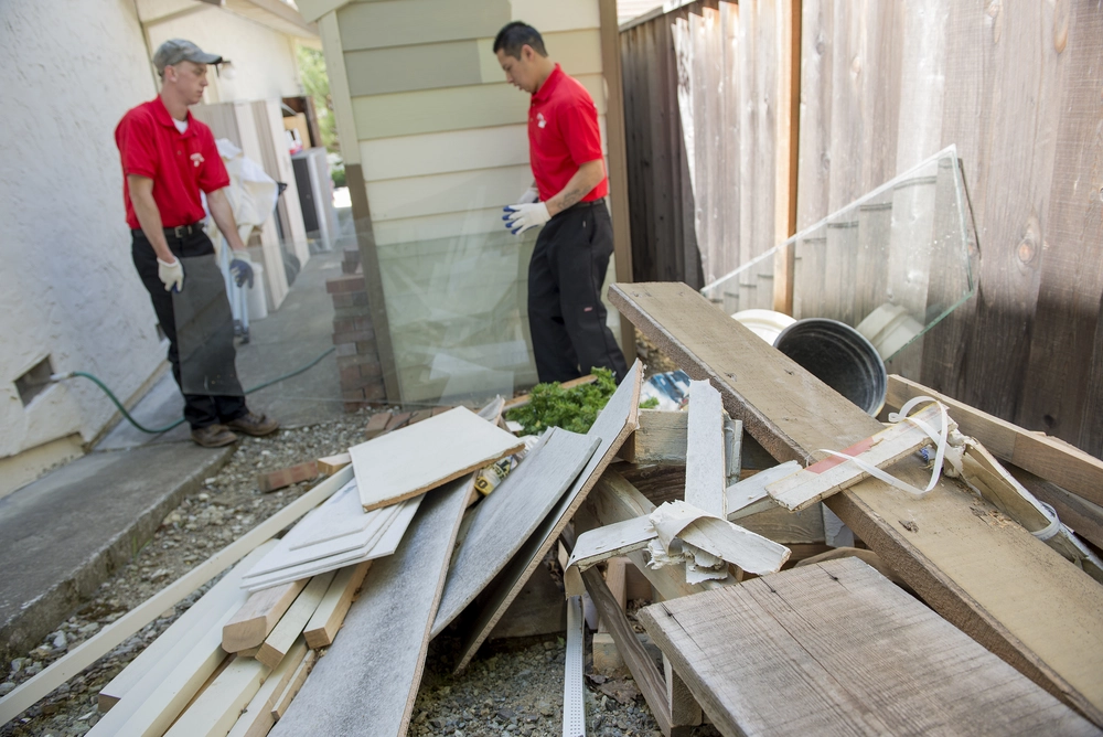 junk-king-two-workers-sorting-renovation-debris sorting construction debris in wake forest